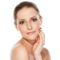 Portrait of a pretty girl with beautiful hands and face over a white background